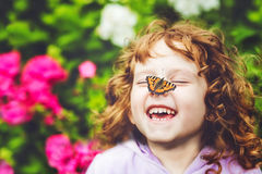 beautiful-little-girl-butterfly-his-nose-laughing-46175405